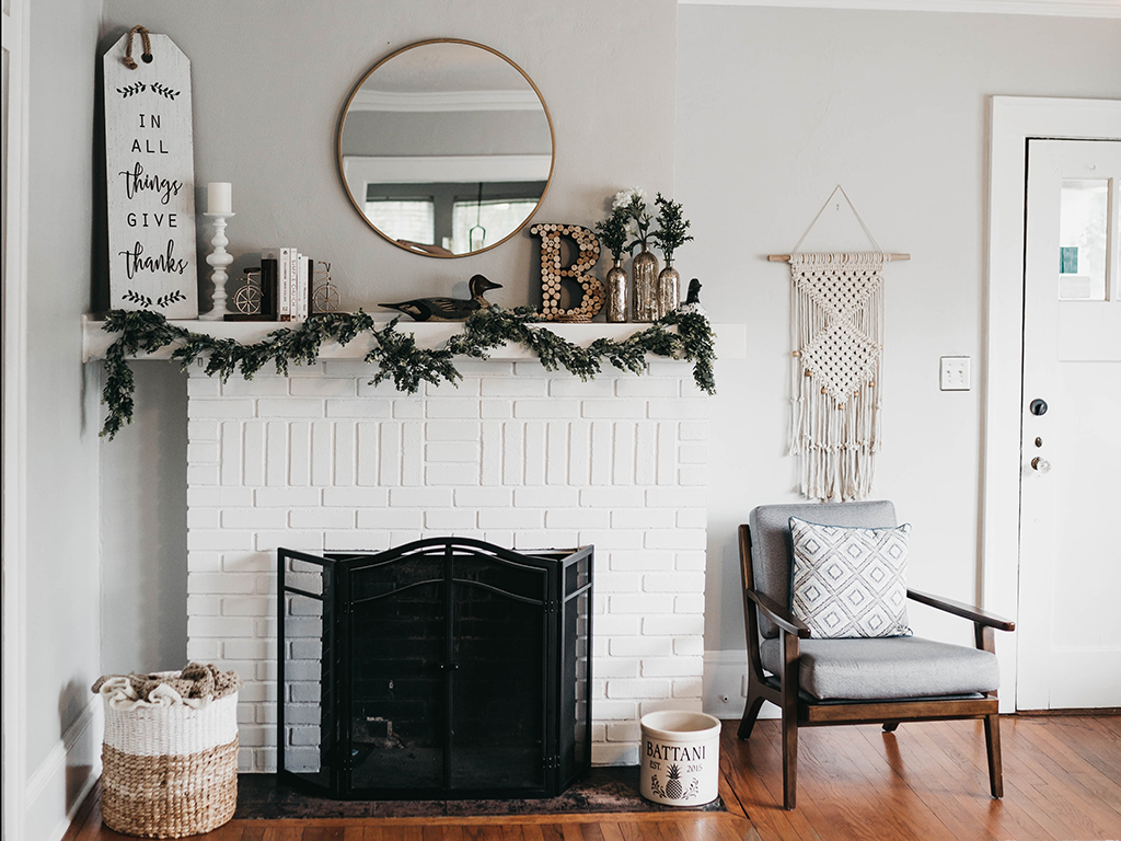 Fireplace decorated with neutral holiday garland.