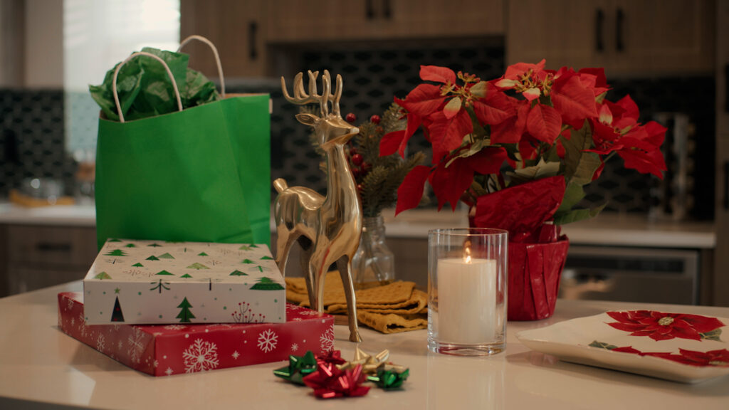 Decorate your apartment for the holidays with candles and poinsettias on kitchen island.