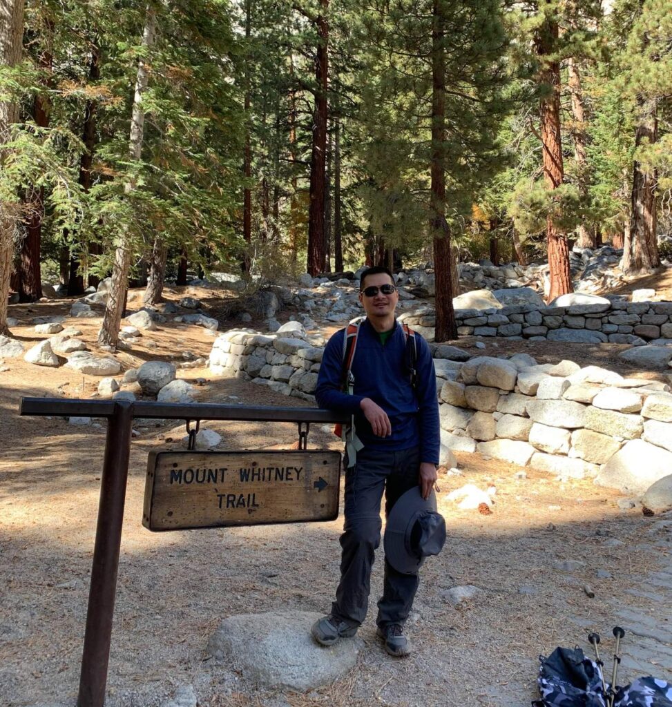 Peter and the Mount Whitney trail sign. Climbing mountains the same way he climbs the corporate ladder in his career at Fairfield.